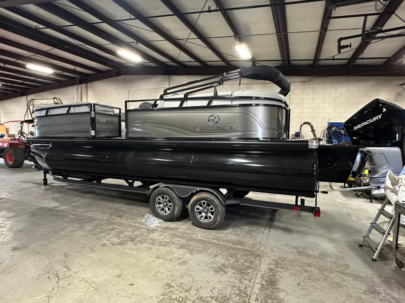 Slide: The Image of 2025 Regency 230 DL3 pontoon boat in a warehouse setting. - 3