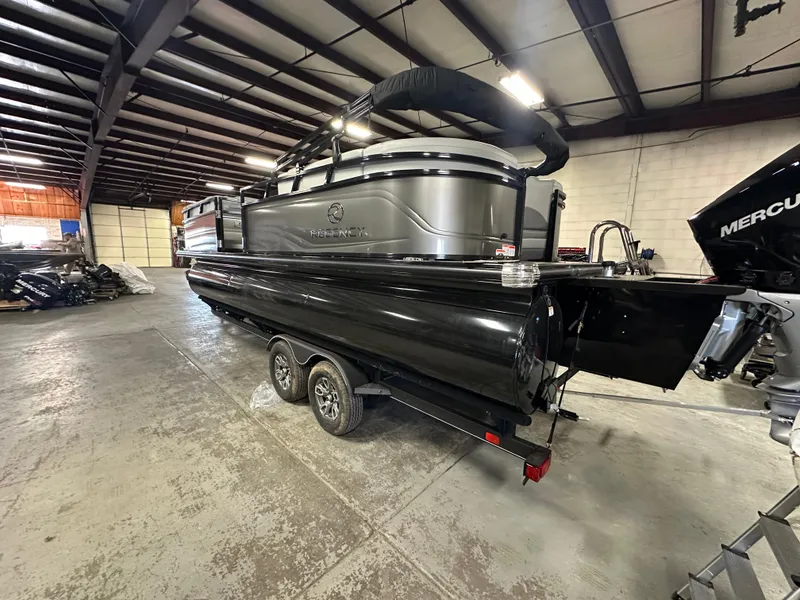 Slide: The Image of 2025 Regency 230 DL3 pontoon boat in warehouse, side view. - 4