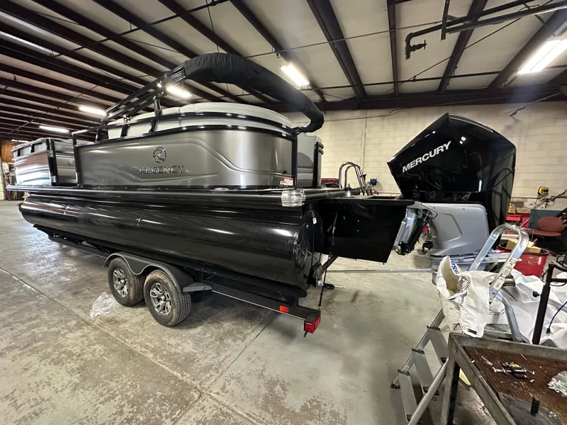 Slide: The Image of 2025 Regency 230 DL3 pontoon boat with Mercury engine in a warehouse setting. - 8