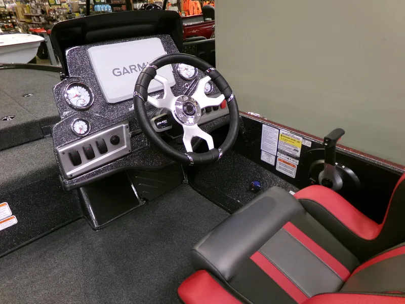 Slide: The Image of 2025 Nitro Z18 boat dashboard with Garmin display and red-accented seat. - 3