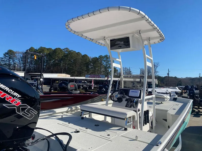 Slide: The Image of 2025 Ranger RB200 boat with T-top and Mercury engine, parked outdoors. - 3