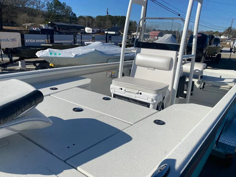 Slide: The Image of 2025 Ranger RB200 boat with seating and console, displayed outdoors in a marina setting. - 7