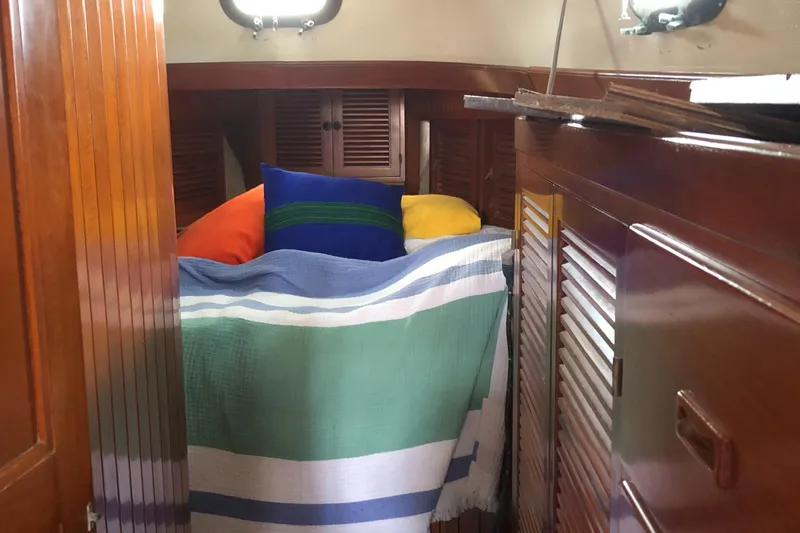 Slide: The Image of Cozy cabin interior of 1985 Tayana 37 sailboat with colorful bedding and wooden accents. - 20
