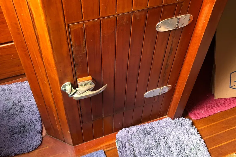 Slide: The Image of Wooden cabinet door with metal latch on 1985 Tayana 37 yacht interior. - 22