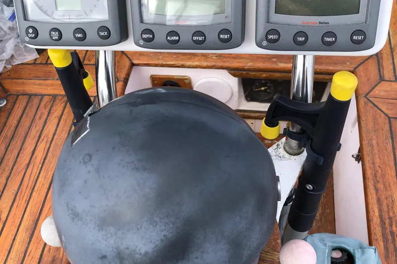 Slide: The Image of Cockpit of 1985 Tayana 37 sailboat with navigation instruments and steering wheel. - 8