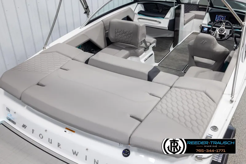 Slide: The Image of 2025 Four Winns H2 boat interior with gray seating and modern dashboard. - 12