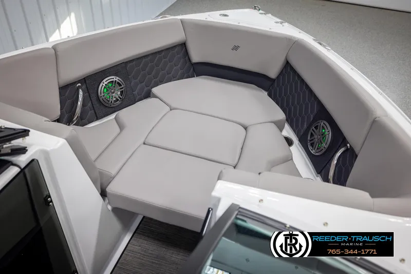 Slide: The Image of 2025 Four Winns H2 boat interior with cushioned seating and built-in speakers. - 21