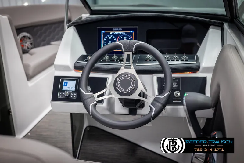Slide: The Image of 2025 Four Winns H2 boat dashboard with modern steering wheel and control panel. - 32