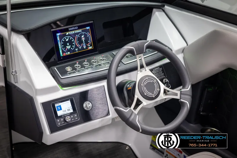Slide: The Image of 2025 Four Winns H2 boat dashboard with steering wheel and digital display. - 33