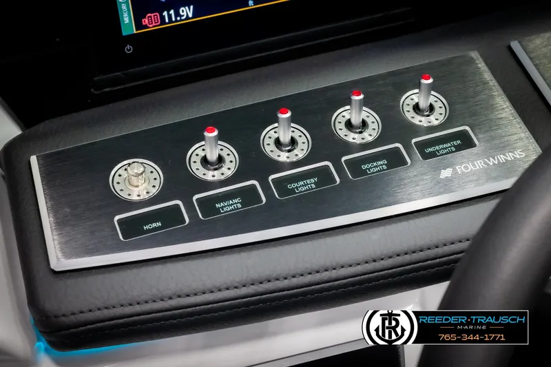 Slide: The Image of Control panel of 2025 Four Winns H2 boat with switches for lights and horn. - 37