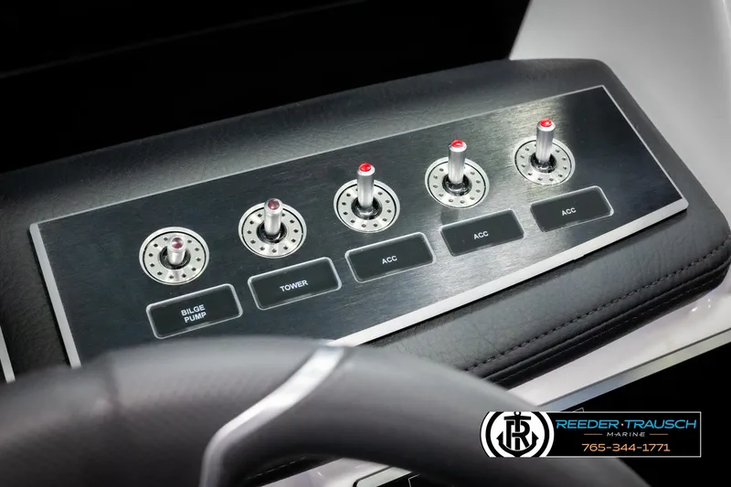 Slide: The Image of 2025 Four Winns H2 boat control panel with switches for bilge pump, tower, and accessories. - 39