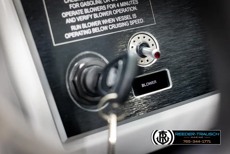 Slide: The Image of 2025 Four Winns H2 boat ignition and blower switch panel with key inserted. - 40