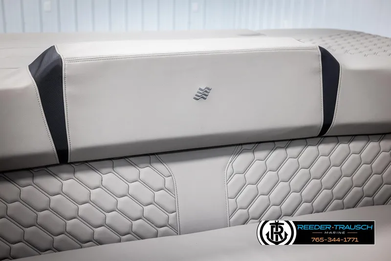Slide: The Image of 2025 Four Winns H2 boat interior with hexagonal pattern upholstery, Reeder-Trausch Marine logo. - 47
