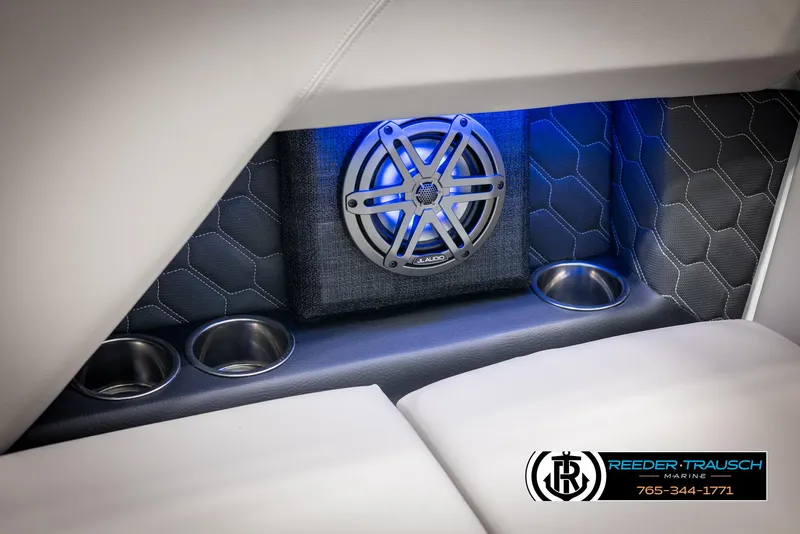 Slide: The Image of 2025 Four Winns H2 boat interior with JL Audio speaker and cup holders, blue ambient lighting. - 48