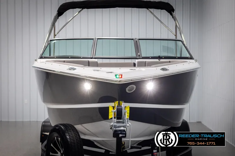 Slide: The Image of 2025 Four Winns H2 boat in showroom, front view with trailer, Reeder-Trausch Marine logo. - 8
