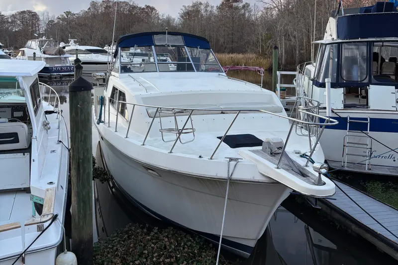Slide: The Image of 1986 Chris-Craft 381 Catalina yacht docked at marina, surrounded by other boats. - 0
