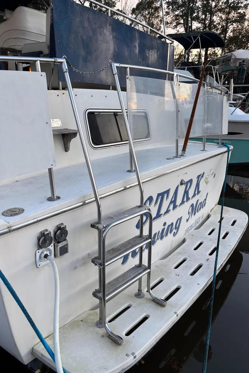 Slide: The Image of 1986 Chris-Craft 381 Catalina boat with ladder and docked at marina. - 11