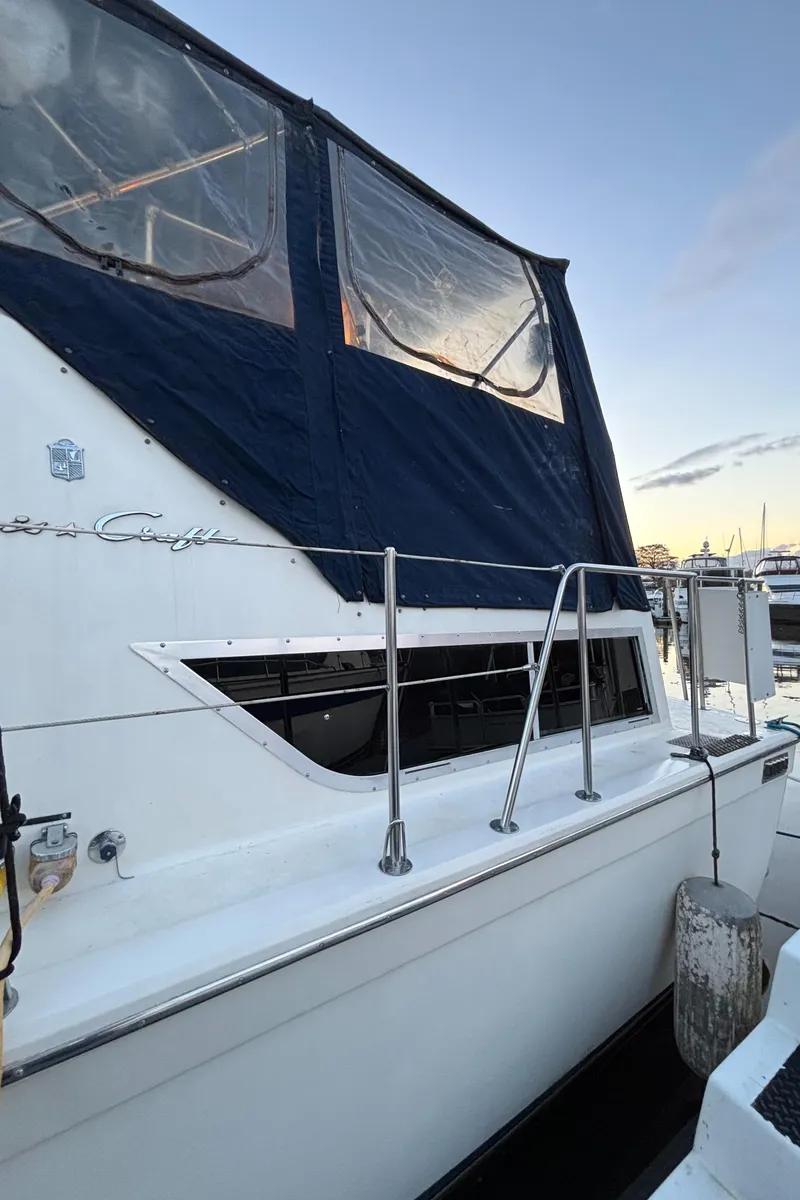 Slide: The Image of 1986 Chris-Craft 381 Catalina boat with blue canvas cover at dock. - 12