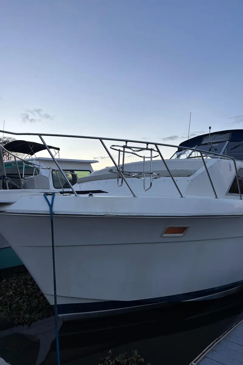 Slide: The Image of 1986 Chris-Craft 381 Catalina boat docked at marina during sunset. - 16