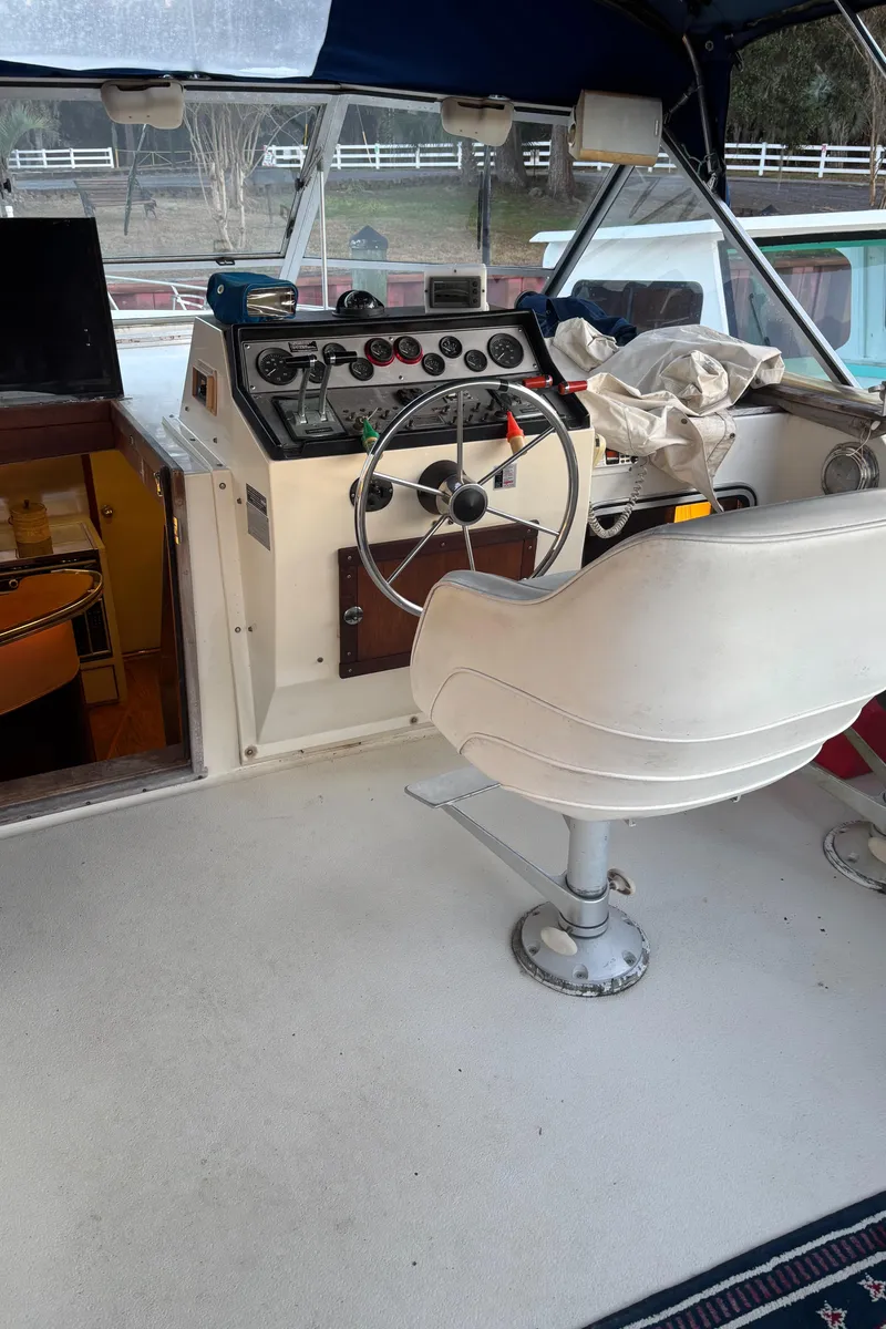 Slide: The Image of 1986 Chris-Craft 381 Catalina boat helm with steering wheel and control panel. - 19