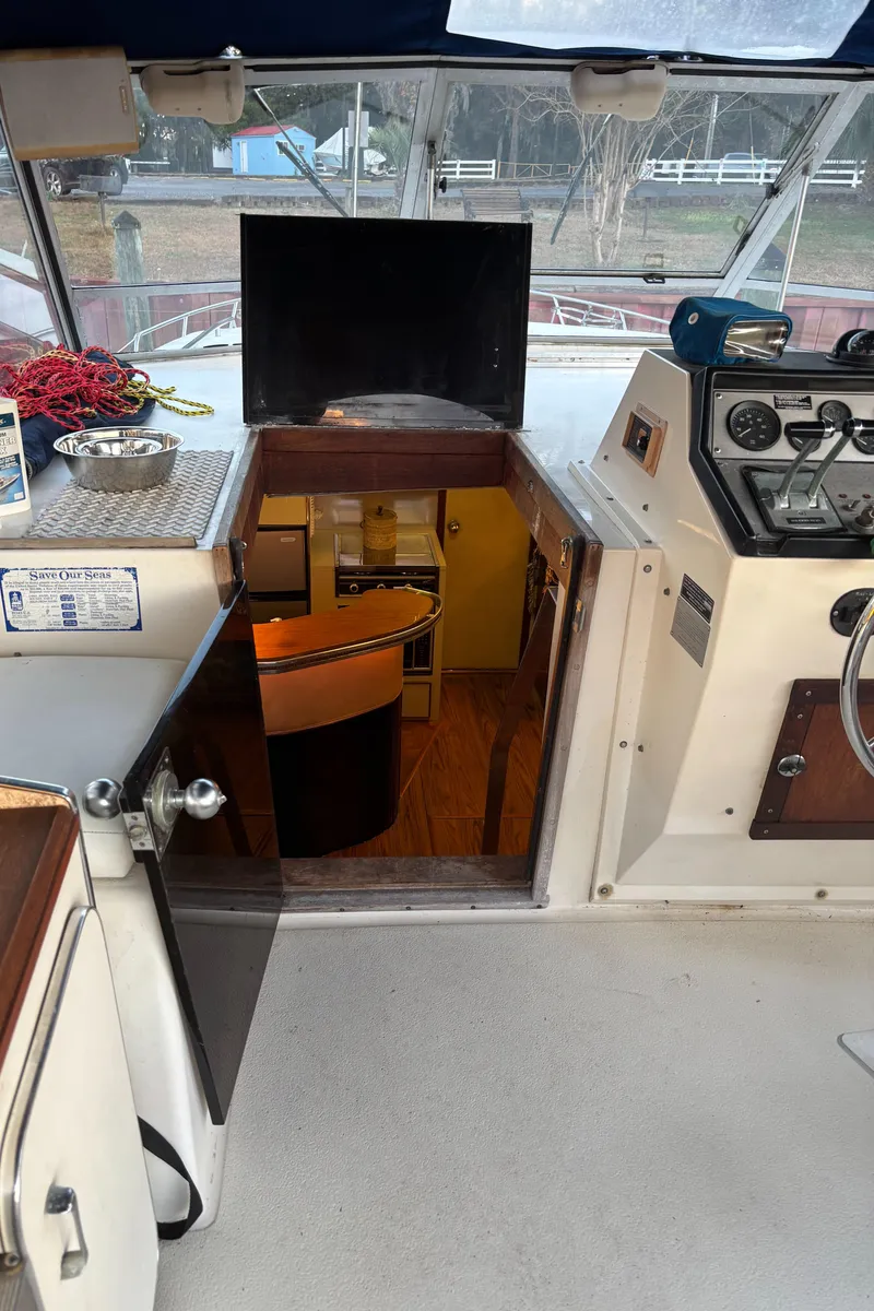 Slide: The Image of 1986 Chris-Craft 381 Catalina interior view with helm and cabin entrance. - 21