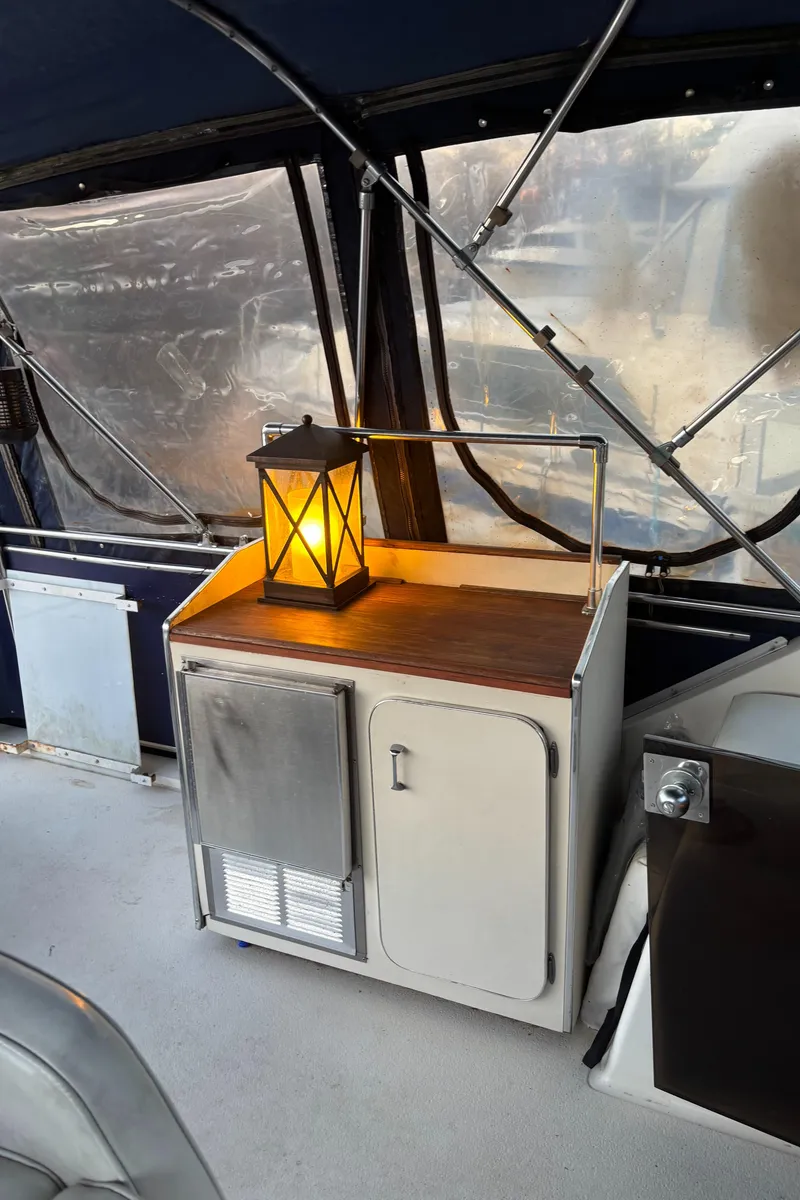 Slide: The Image of 1986 Chris-Craft 381 Catalina interior with lantern on wooden cabinet. - 22