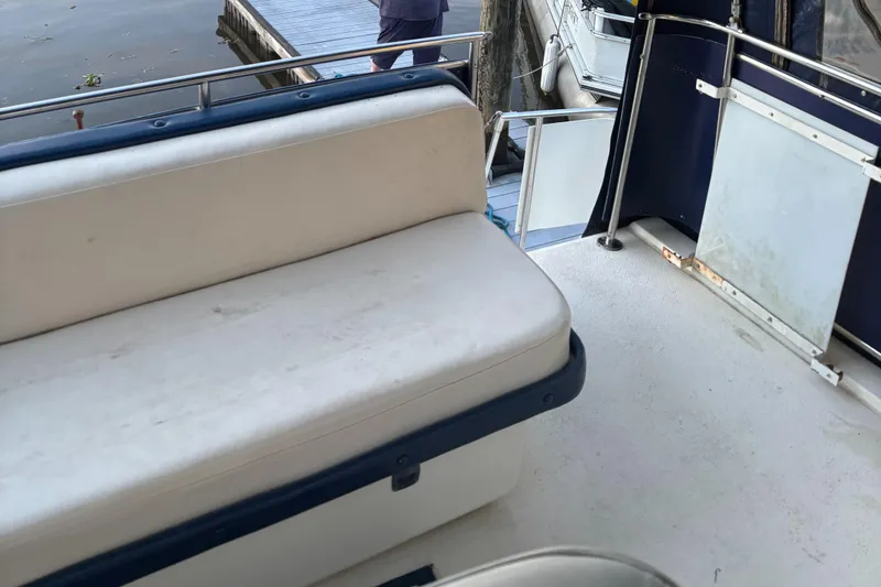 Slide: The Image of 1986 Chris-Craft 381 Catalina boat interior with white seating and railing. - 24