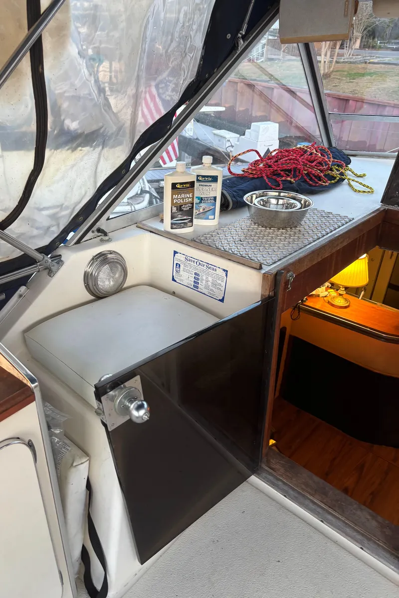 Slide: The Image of 1986 Chris-Craft 381 Catalina boat interior with cleaning supplies and nautical decor. - 25