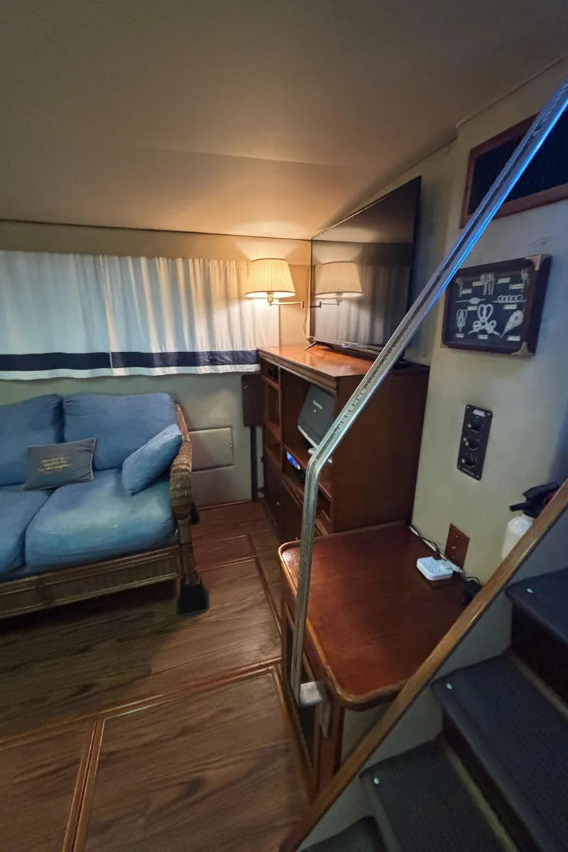 Slide: The Image of Interior of 1986 Chris-Craft 381 Catalina with cozy seating and wooden accents. - 26