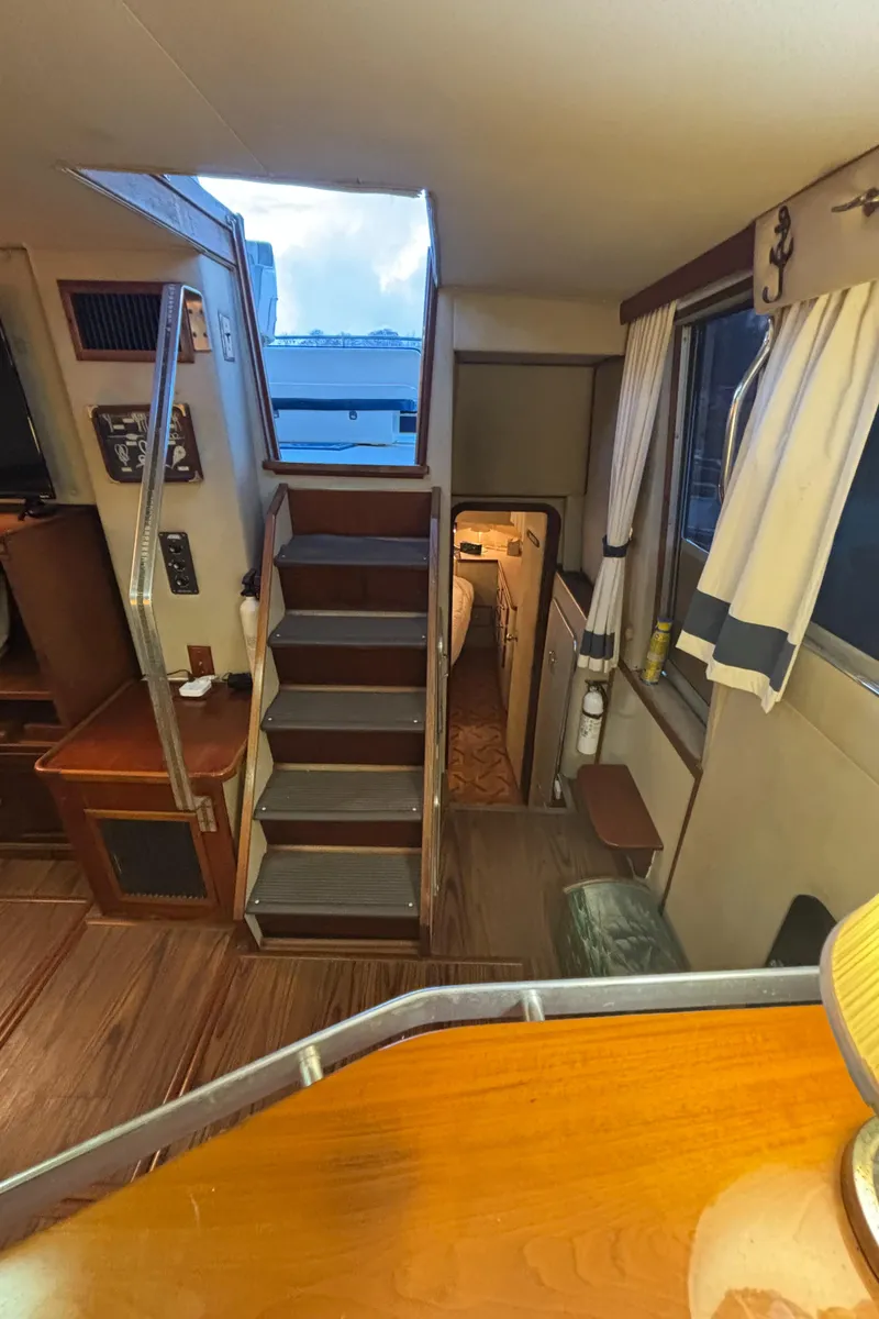 Slide: The Image of Interior of 1986 Chris-Craft 381 Catalina yacht with wooden stairs and cozy cabin. - 27