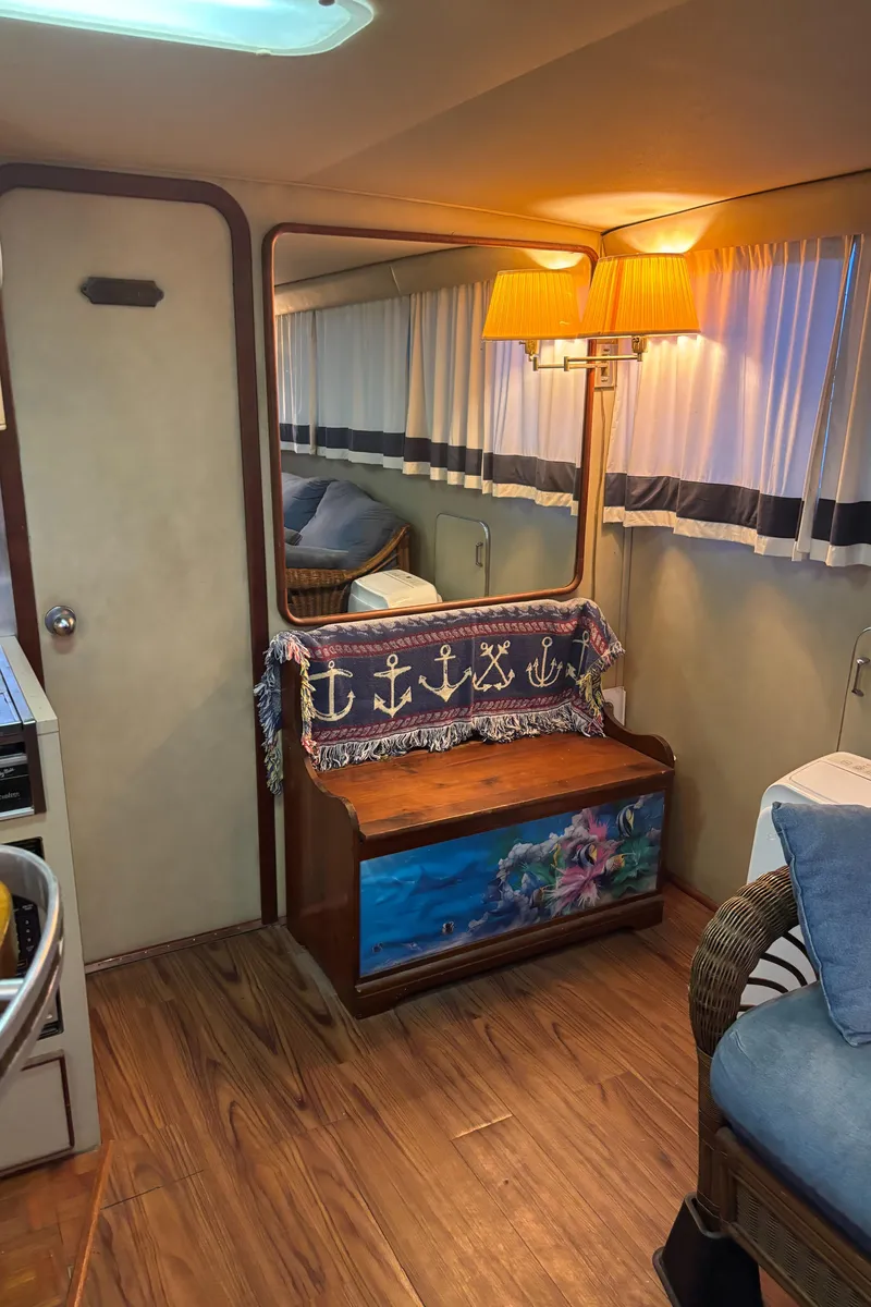 Slide: The Image of Interior of 1986 Chris-Craft 381 Catalina with nautical decor and cozy seating. - 28