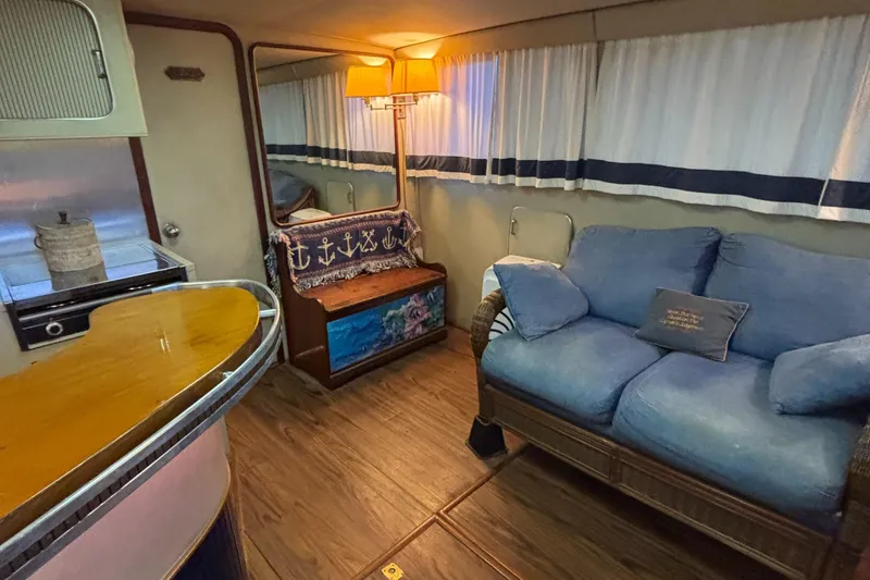 Slide: The Image of 1986 Chris-Craft 381 Catalina interior with cozy seating and nautical decor. - 29