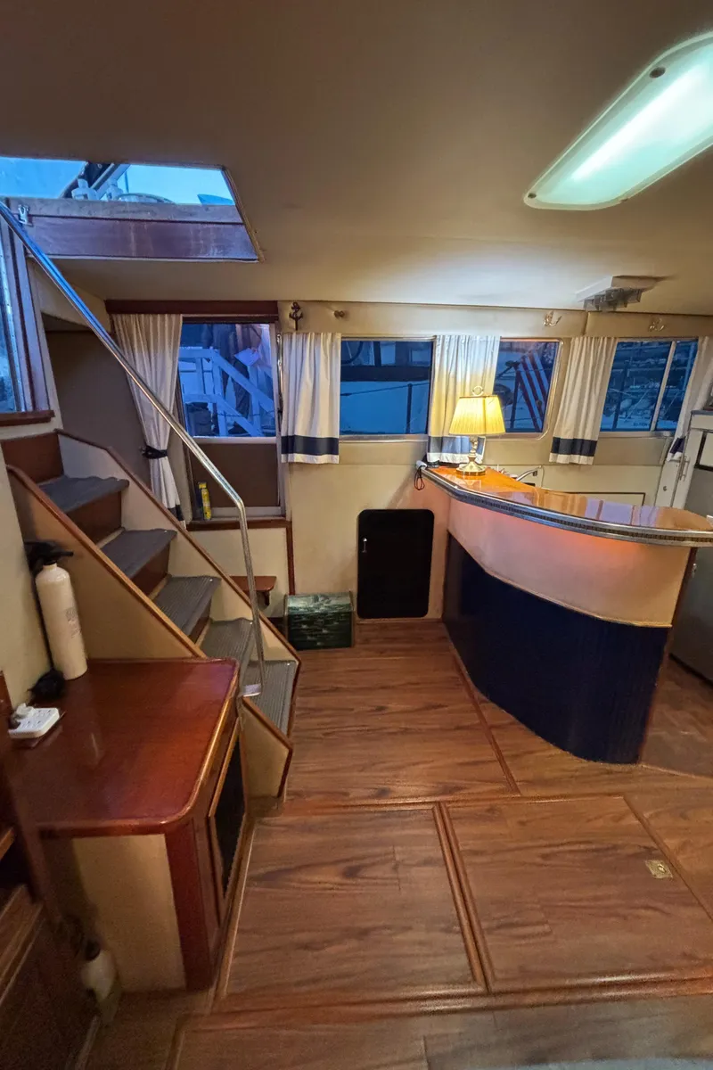 Slide: The Image of Interior of 1986 Chris-Craft 381 Catalina yacht with wooden flooring and cozy lighting. - 31