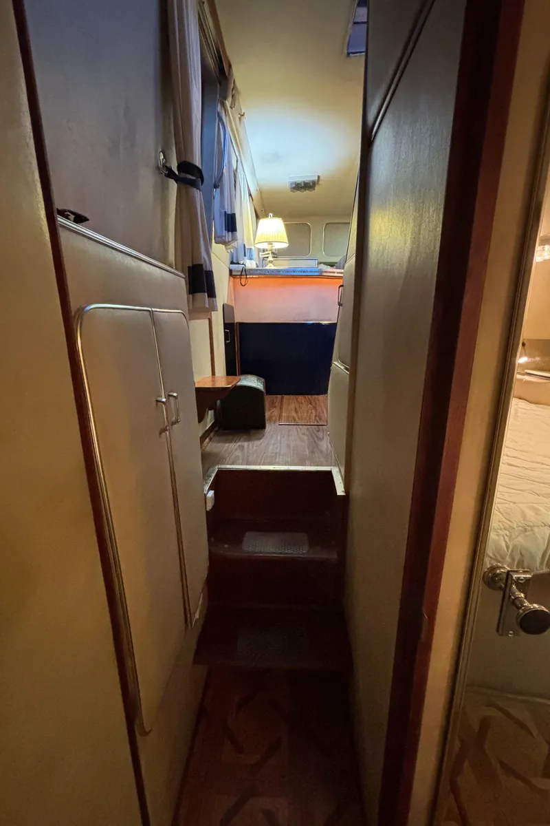 Slide: The Image of Interior hallway of 1986 Chris-Craft 381 Catalina yacht, featuring cozy lighting and wooden accents. - 34
