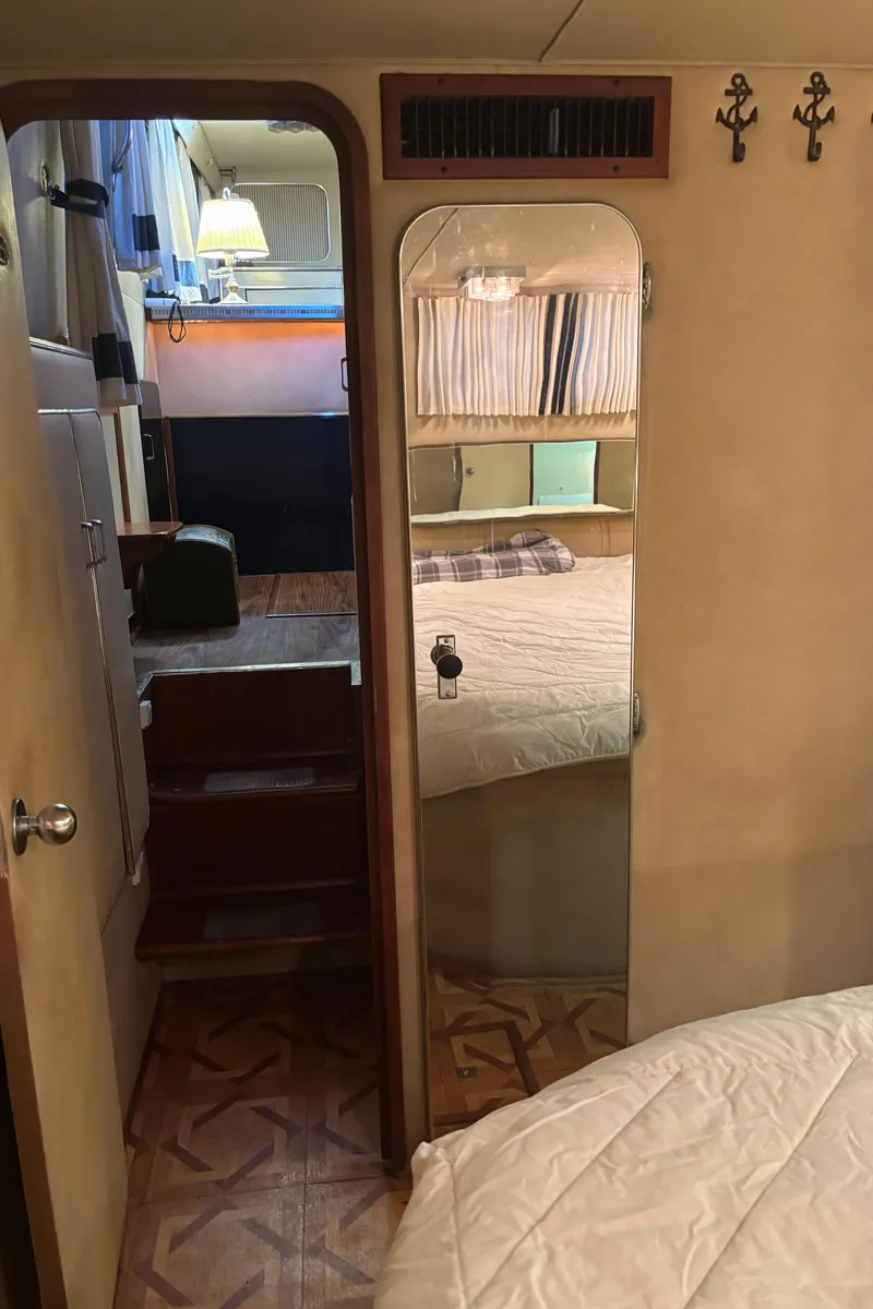 Slide: The Image of 1986 Chris-Craft 381 Catalina interior with cozy bedroom and wooden accents. - 36