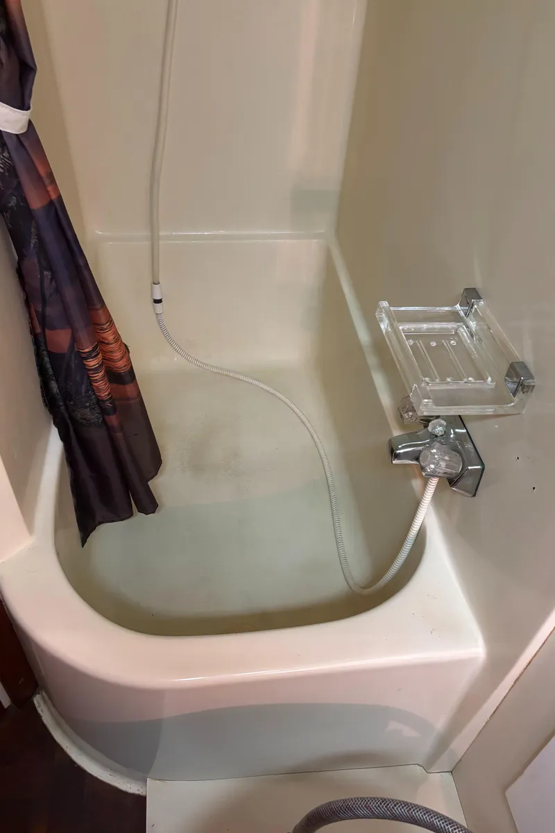 Slide: The Image of 1986 Chris-Craft 381 Catalina boat shower with curtain and handheld showerhead. - 38