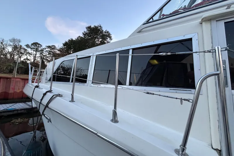 Slide: The Image of 1986 Chris-Craft 381 Catalina yacht docked, side view with railing and windows. - 4