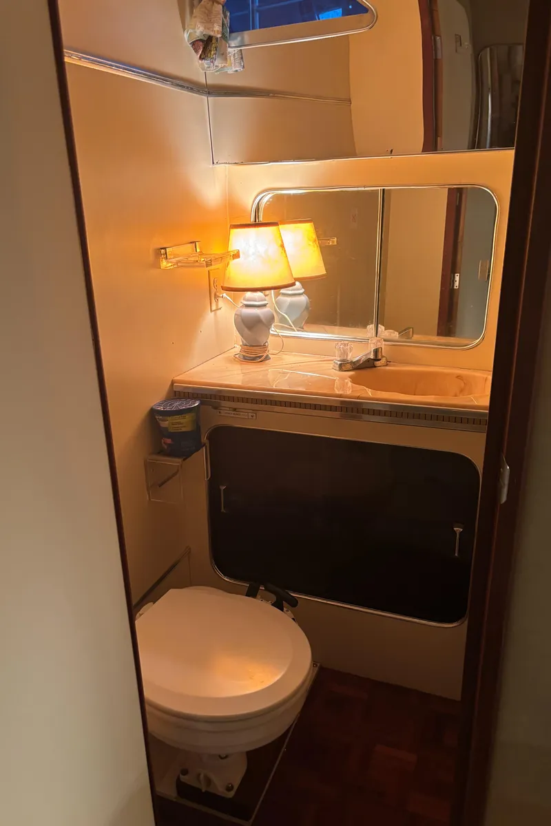 Slide: The Image of 1986 Chris-Craft 381 Catalina bathroom with lamp, mirror, and toilet. - 47