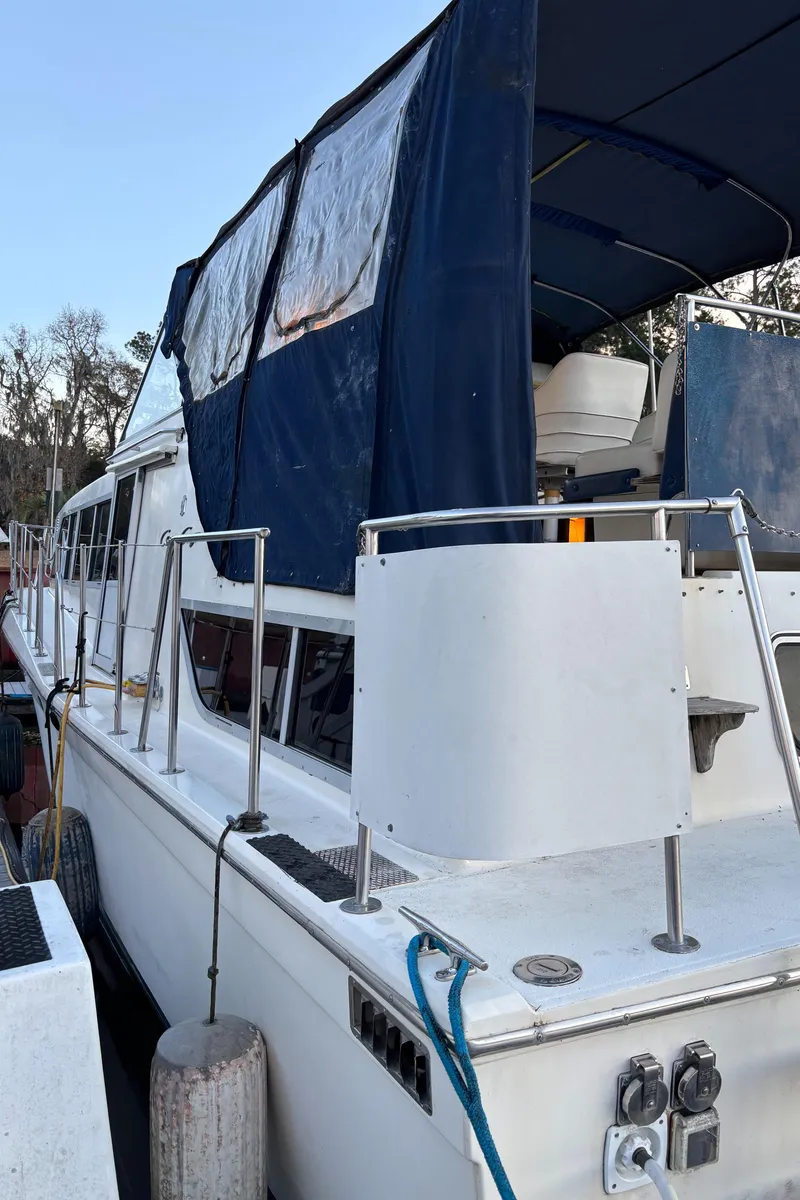 Slide: The Image of 1986 Chris-Craft 381 Catalina yacht with blue canopy docked at marina. - 9