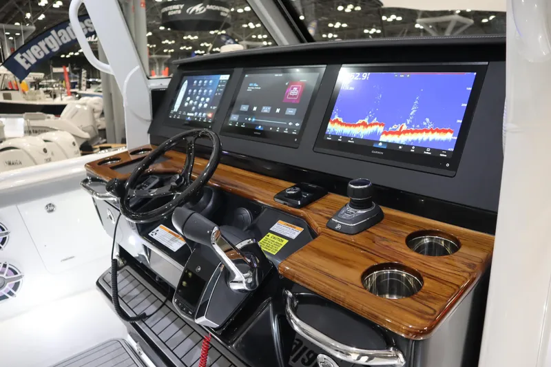 Slide: The Image of 2025 Everglades 395 Center Console boat dashboard with advanced navigation displays. - 10