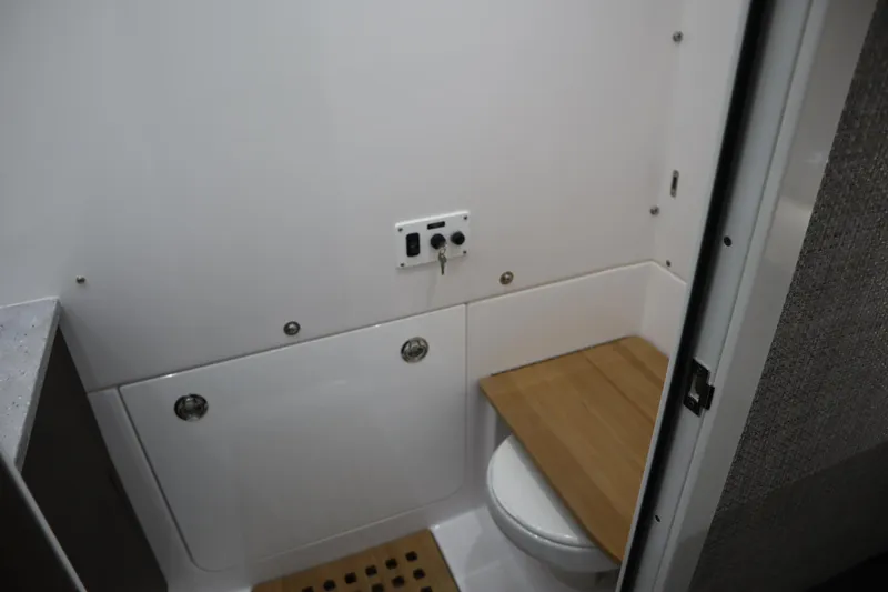 Slide: The Image of Interior of 2025 Everglades 395 Center Console boat bathroom with modern fixtures. - 13
