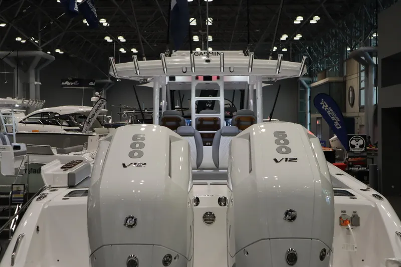 Slide: The Image of 2025 Everglades 395 Center Console with twin V12 engines at a boat show. - 3