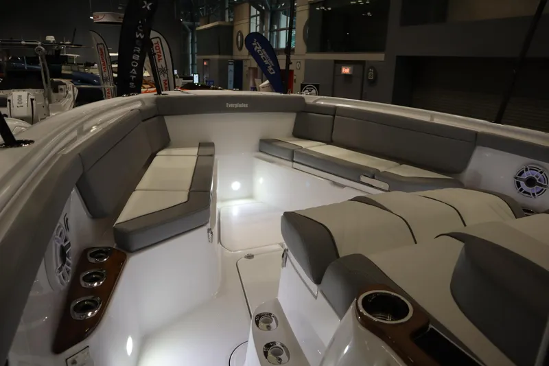 Slide: The Image of 2025 Everglades 395 Center Console boat interior with cushioned seating and cup holders. - 5