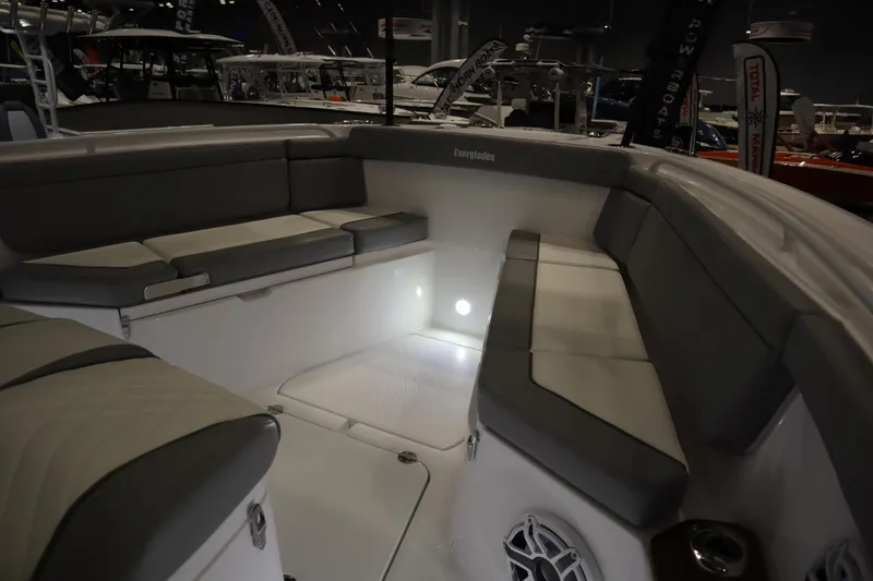 Slide: The Image of 2025 Everglades 395 Center Console boat interior with cushioned seating and ambient lighting. - 6