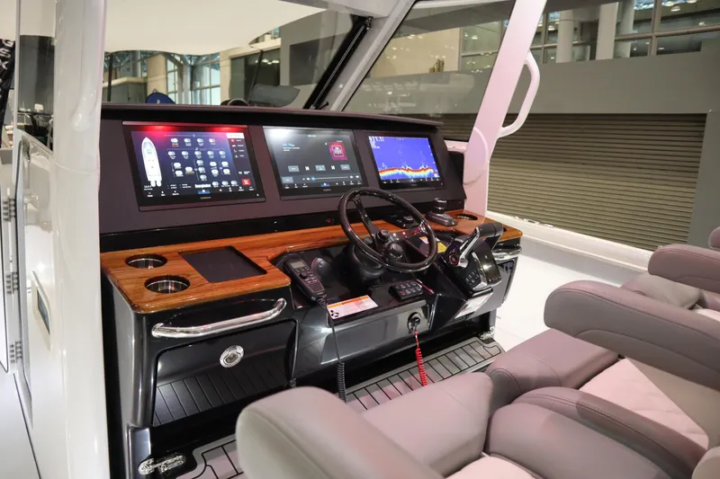 Slide: The Image of 2025 Everglades 395 Center Console boat interior with advanced navigation displays. - 9