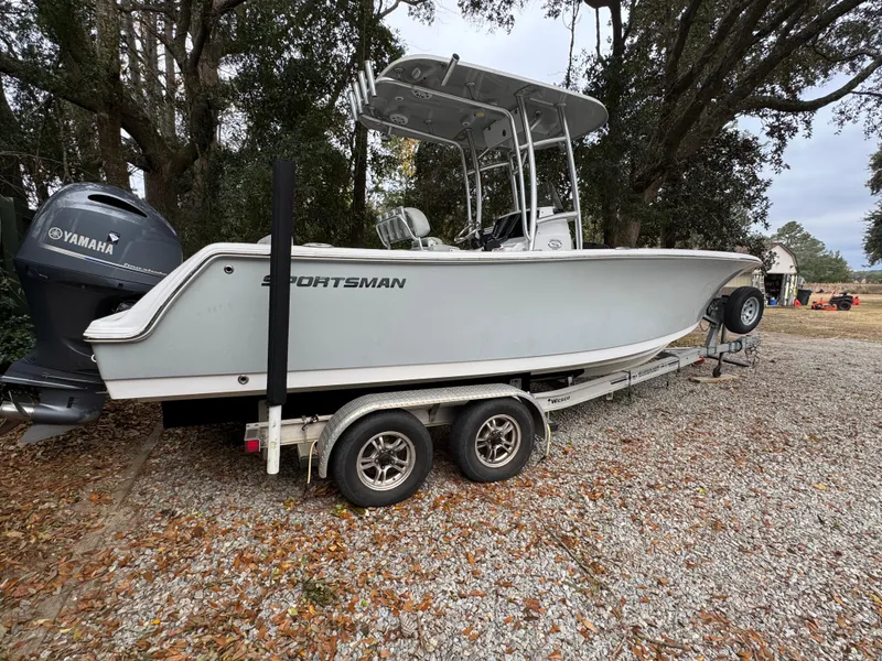 Slide: The Image of 2019 Sportsman Heritage 231 Center Console boat on trailer, parked outdoors. - 0