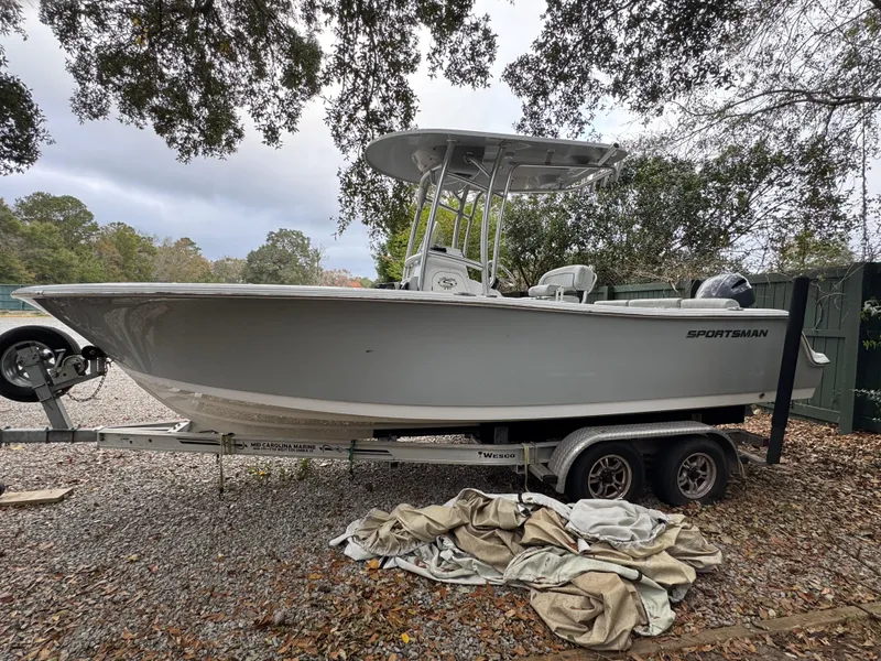 Slide: The Image of 2019 Sportsman Heritage 231 Center Console boat on trailer, parked outdoors. - 2