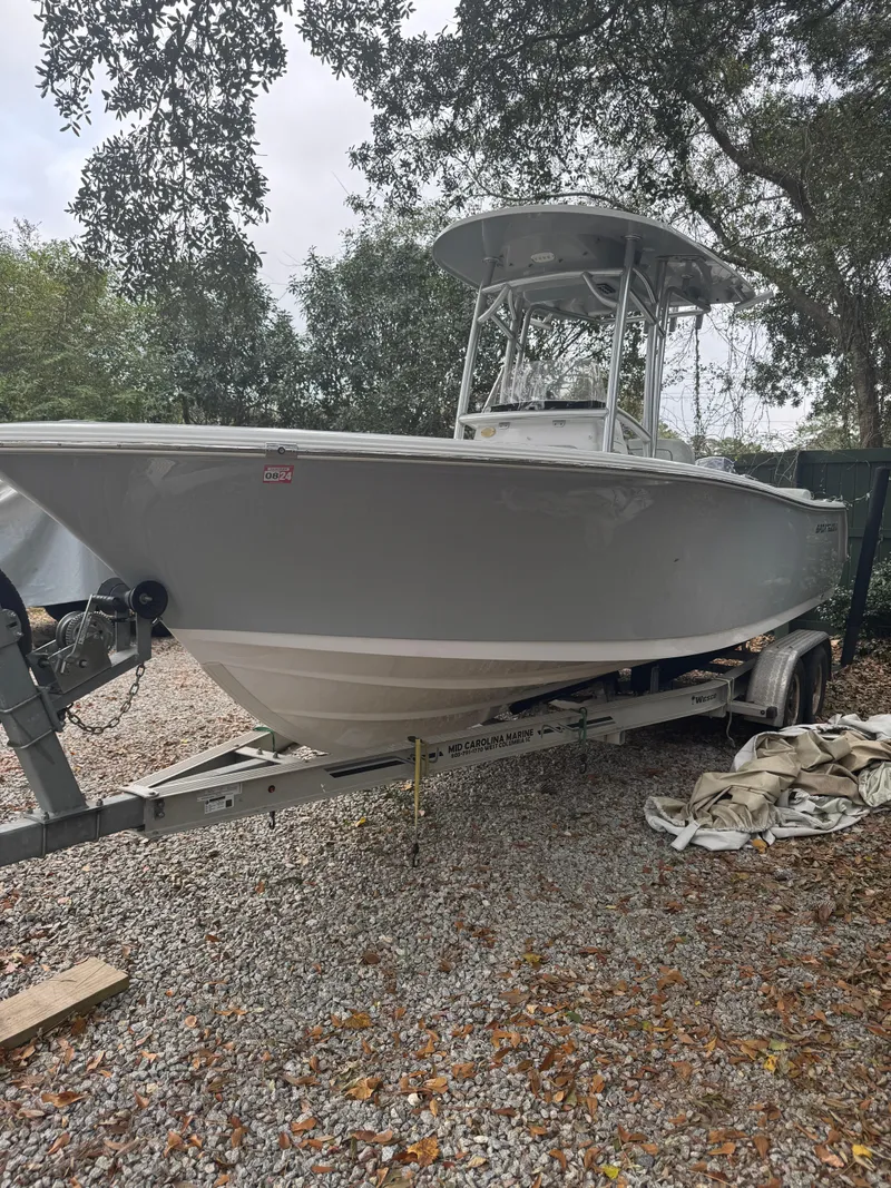 Slide: The Image of 2019 Sportsman Heritage 231 Center Console boat on trailer, parked outdoors. - 3