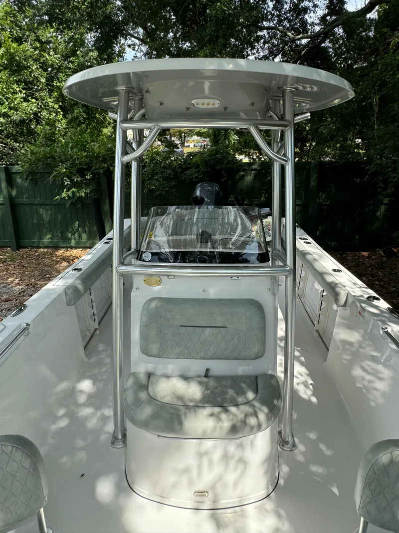 Slide: The Image of 2019 Sportsman Heritage 231 Center Console boat with T-top in a wooded area. - 5