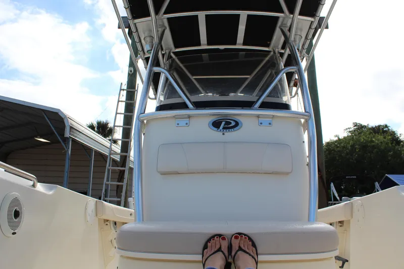 Slide: The Image of 2008 Pursuit C230 boat with a center console and canopy, viewed from the deck. - 21